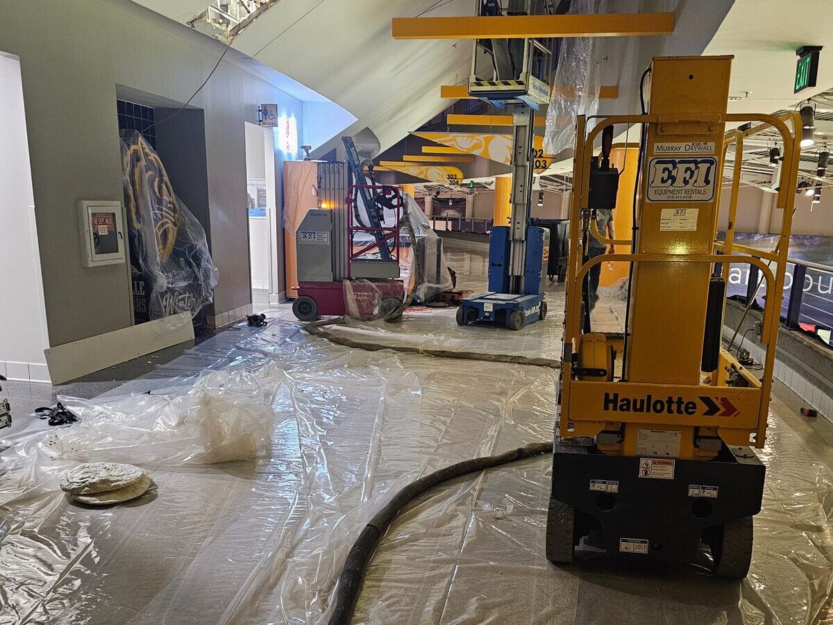 Volunteer FoamPros spray hose, lift and floor protection in place on the concourse during the Bridgestone Arena project in Nashville
